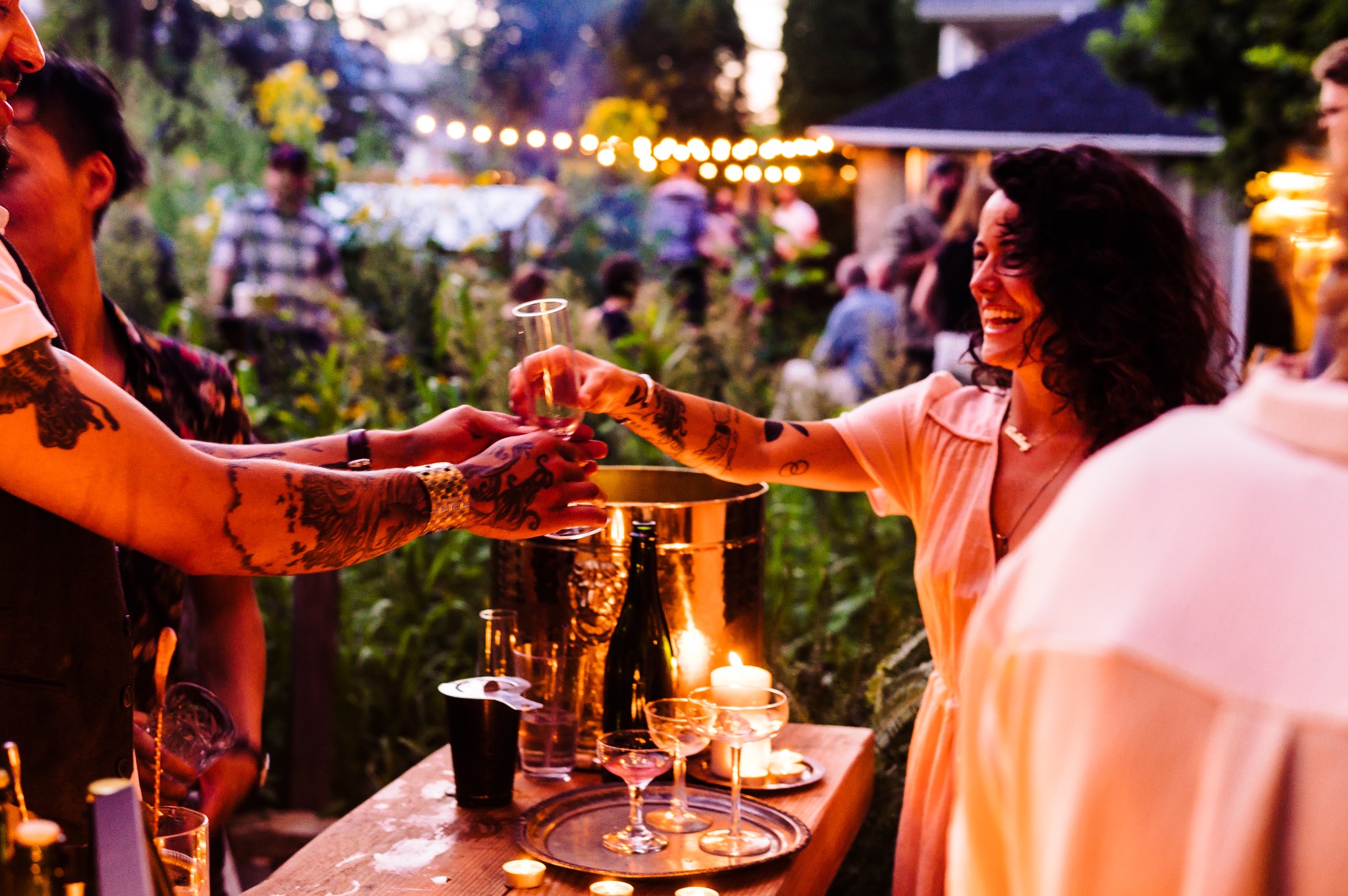 Backyard string lights and candlelit bar at dusk