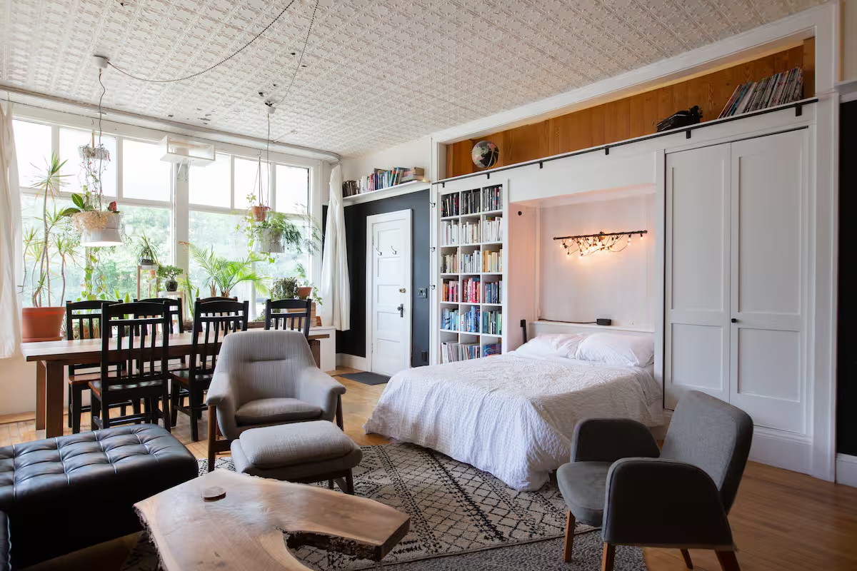 Murphy bed open — tin ceiling and full living space