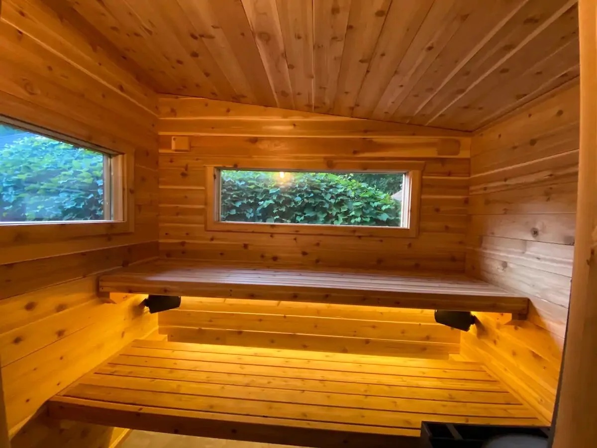 Wood-burning sauna interior with cedar benches