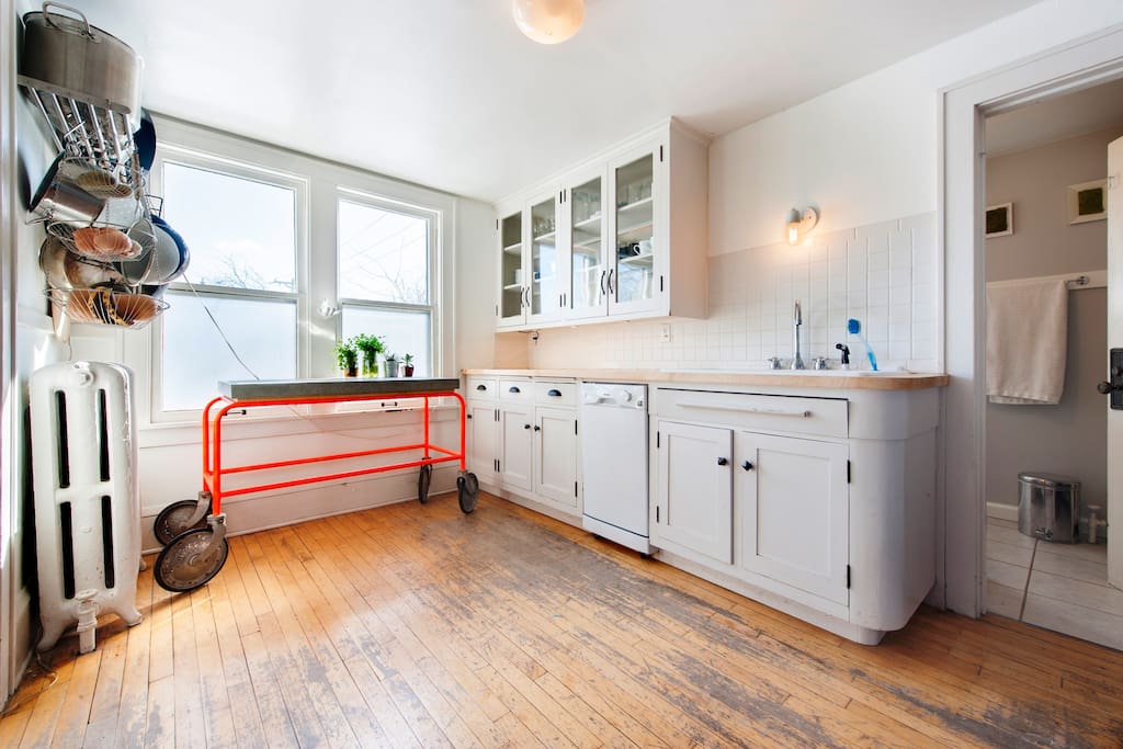 Fully equipped kitchen with white cabinets and gas range